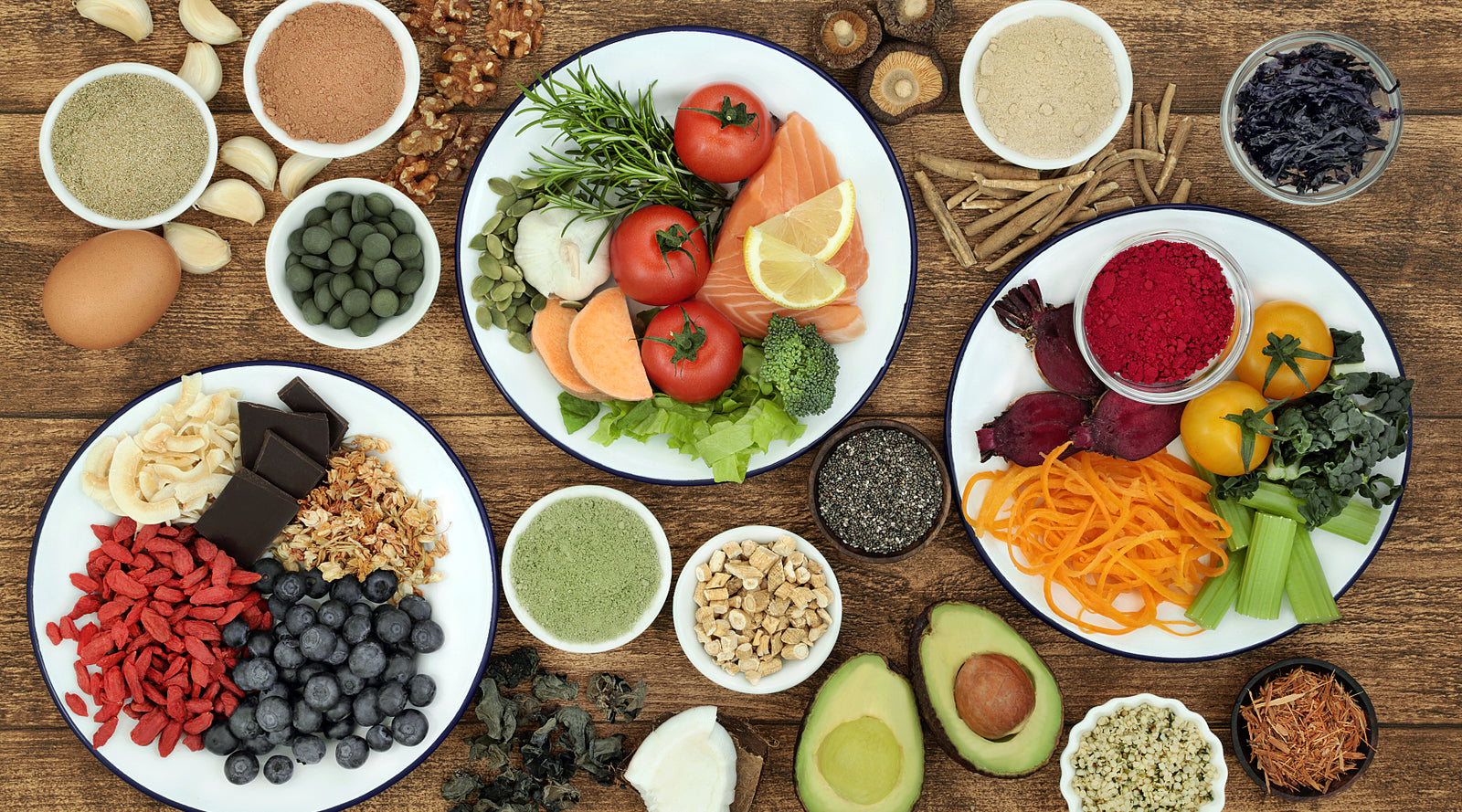 Whole foods on dishes spread out on a wooden table