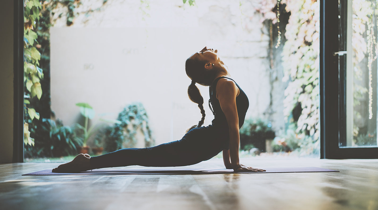 Man and woman riding bike on sidewalk along the water.