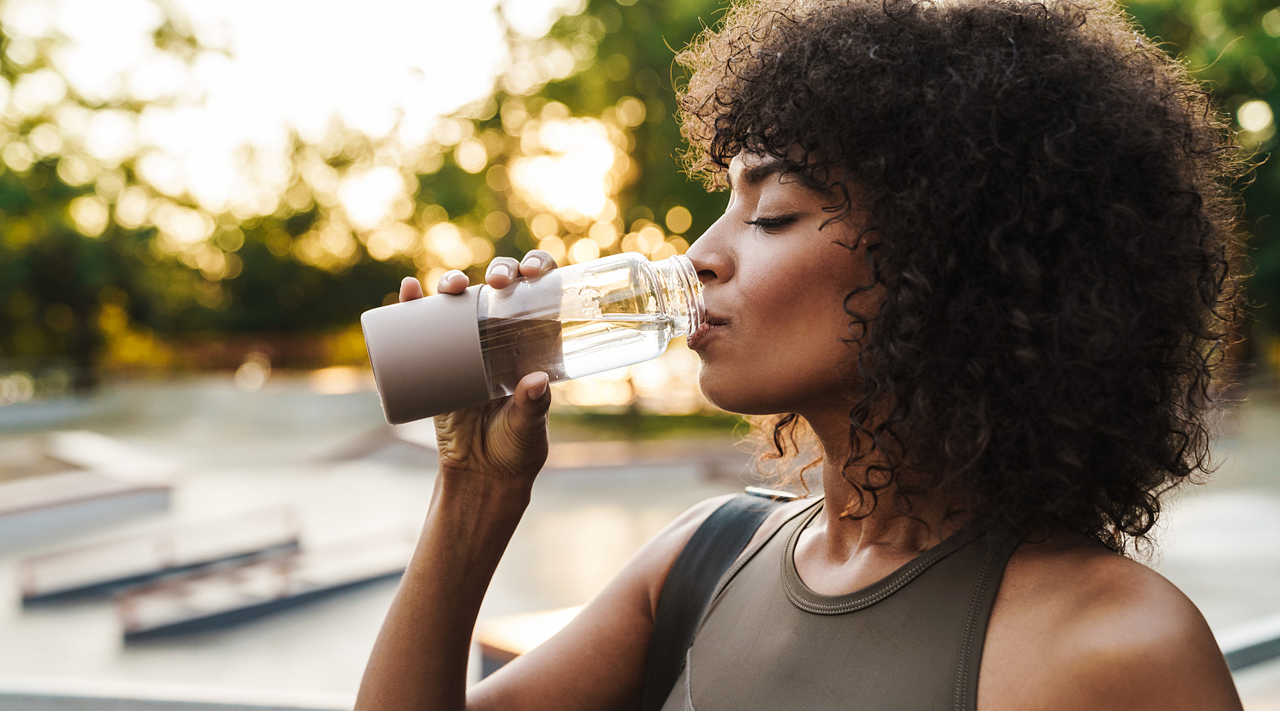 Woman drinking water outdoors